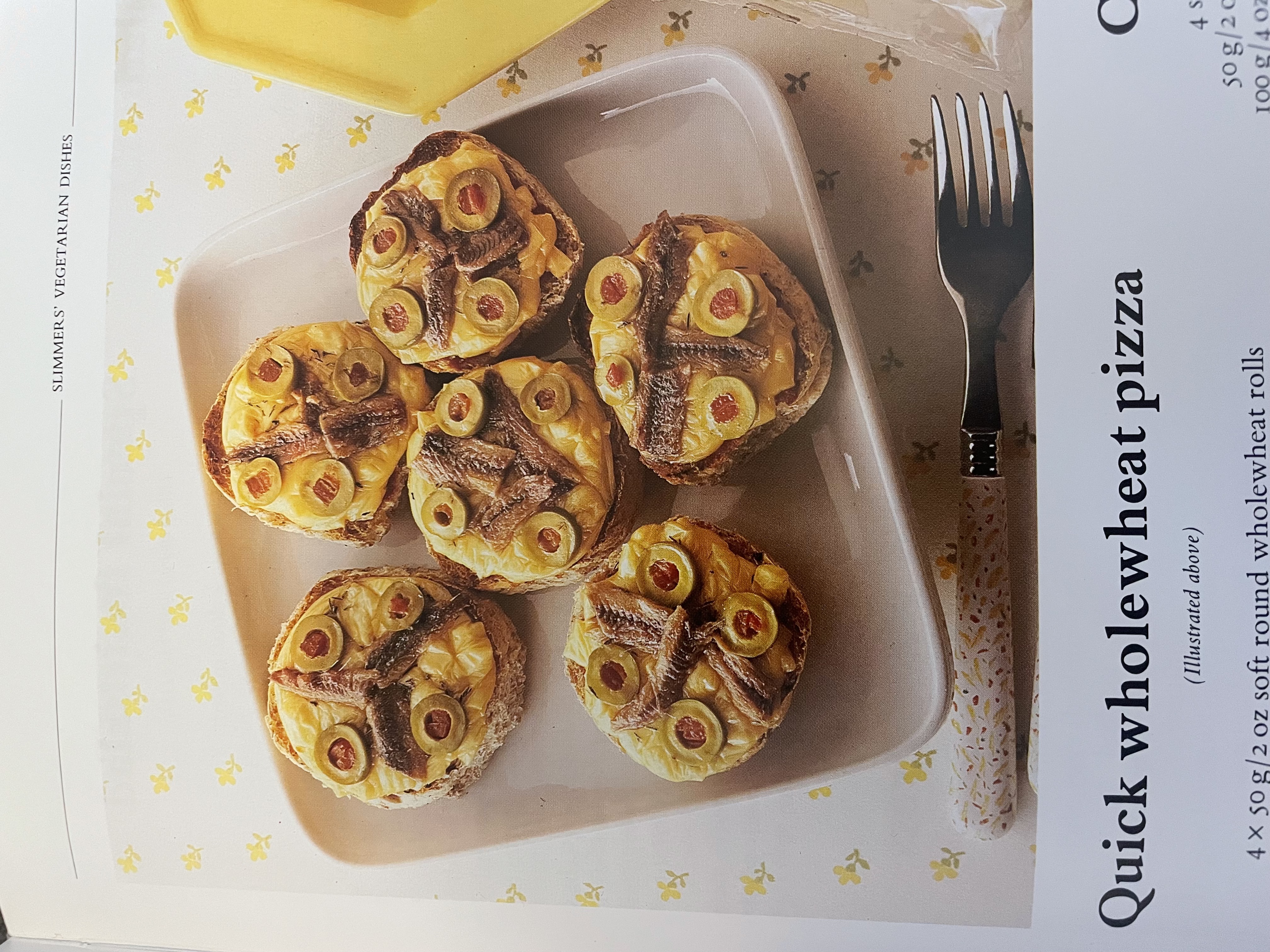 A recipe for Quick Wholewheat Pizza with a photo of 5 English muffin pizzas with four sliced green olives with pimentos and 3 anchovy slives on each one over melted cheddar cheese.